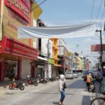 Urban Markets - A street with people walking and bicycles on it