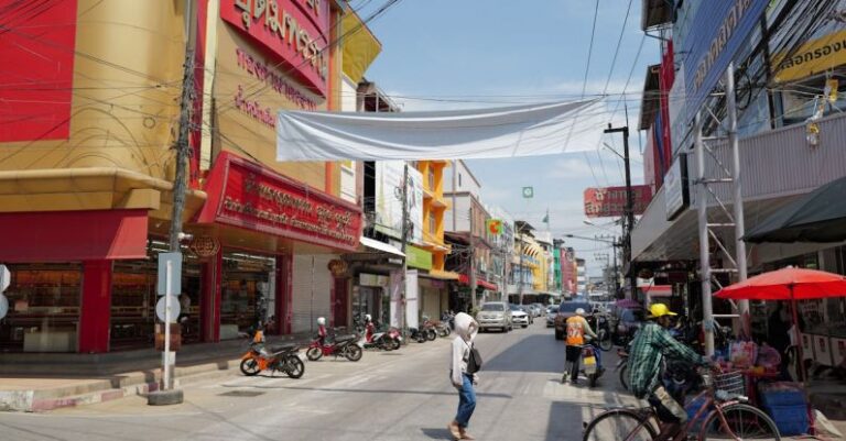 Urban Markets - A street with people walking and bicycles on it