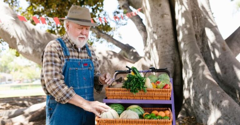 Farmers Markets - A Farmer Standing by a Fruit Stand