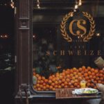 Consumer Preferences - Man in Brown Jacket Sitting on Chair in Front of Fruit Stand