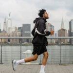 Urban Sports - Man Wearing Jacket and Black Shorts Running in the City