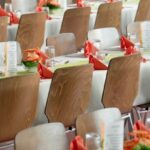 Event Management - Long Tables With White Cloths and Brown Chairs Formal Setting