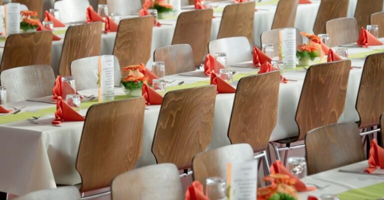 Event Management - Long Tables With White Cloths and Brown Chairs Formal Setting