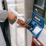 Transport Accessibility - Side view of crop unrecognizable female in stylish clothes using credit card while buying metro ticket via electronic machine