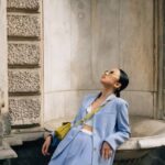 Architectural Diversity - Woman in Blue Suit and Sunglasses Leaning on Building