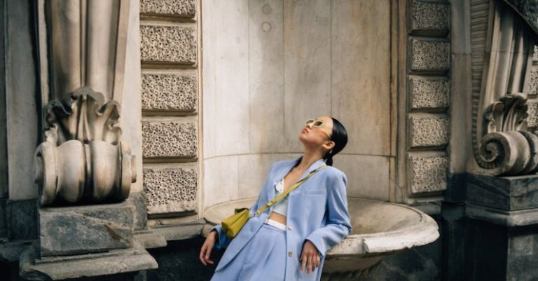 Architectural Diversity - Woman in Blue Suit and Sunglasses Leaning on Building