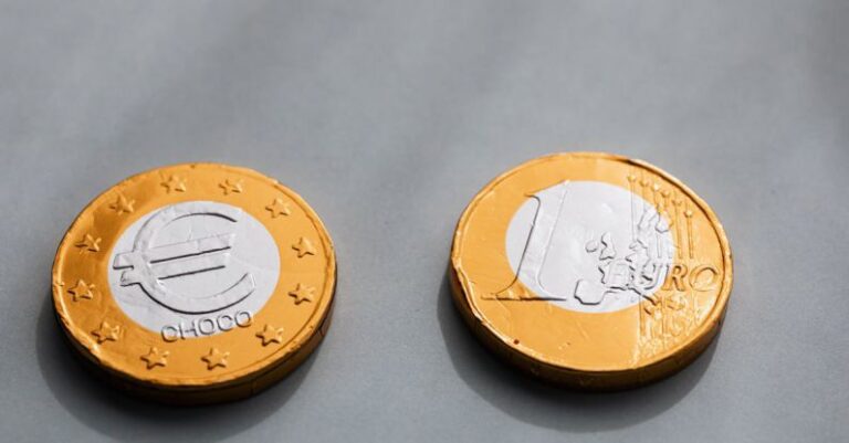 Property Values - Coins one euros lying on gray table