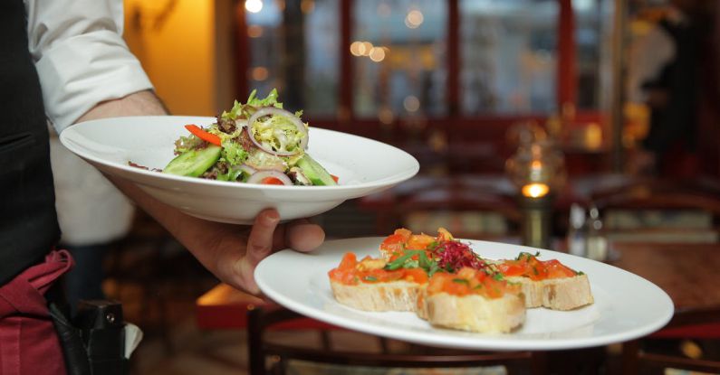 Restaurants - Person Holding Pastry Dishes on White Ceramic Plates