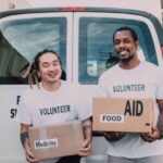 Food Distribution - Volunteer Men Holding Medicine and Food Relief Supplies