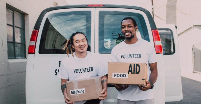 Food Distribution - Volunteer Men Holding Medicine and Food Relief Supplies