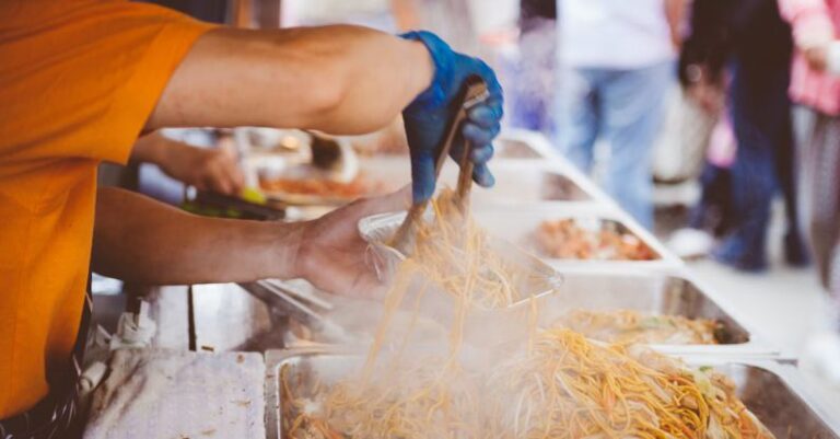 Street Food - Person in Orange Shirt Holding Aluminum Rectangular Container