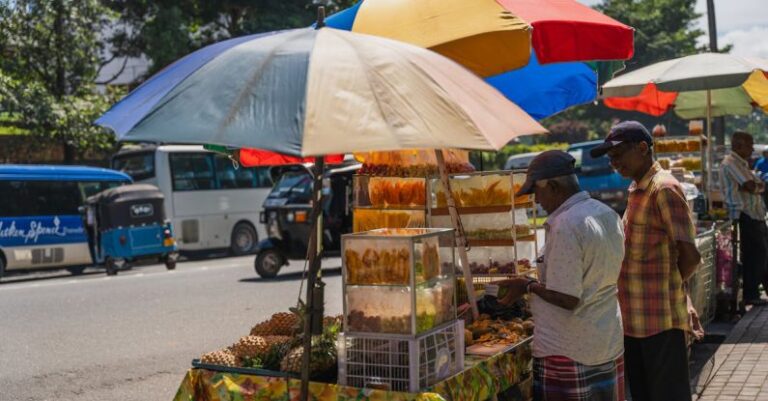 Food Tourism - A man selling fruit on a street corner