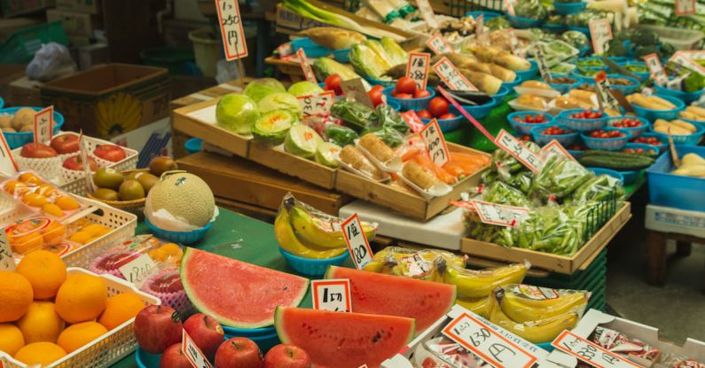 Local Economies - Colorful fruits and vegetables placed on counter in local market