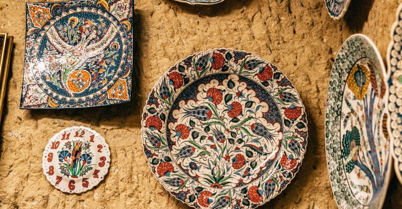 Artisan Markets - Ceramic decorative handmade plates with various ornaments hanging on stone wall in Morocco